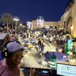 DJ SouthLAnd performing with a large event crowd behind him.