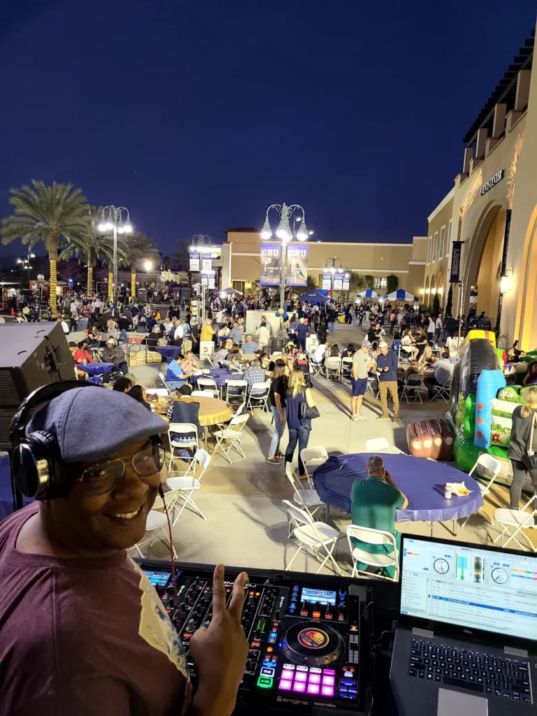 DJ SouthLAnd performing with a large event crowd behind him.
