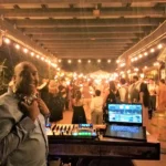 DJ SouthLAnd at his booth during a wedding sparkler celebration.